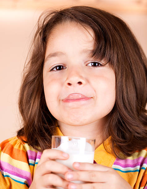 istock Little girl drinking milk 182895737