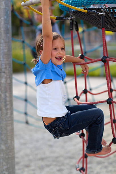 istock happy young girl on playground 182896096