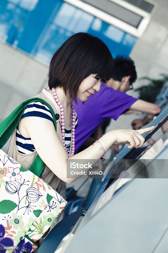 Ragazza asiatica acquistare il biglietto - Foto stock royalty-free di 25-29 anni