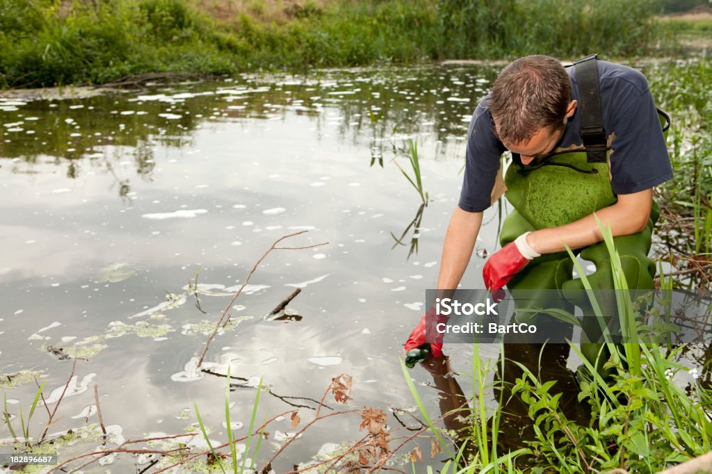 Taking samples of the soil and water, environmental research If you want more related images with environmental research click here. Scientific Experiment Stock Photo