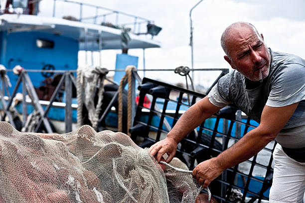 istock Fisherman Holding Fishing Net 182896970
