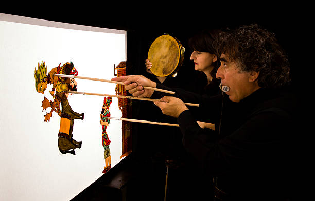 Man and woman putting on puppet show