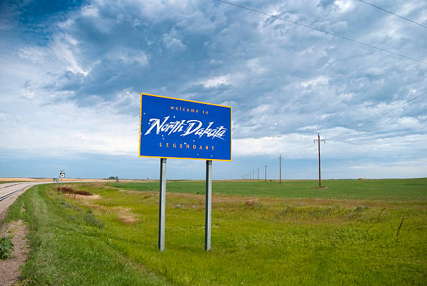 Welcome to North Dakota Welcome to North Dakota sign along the border with South Dakota. north dakota stock pictures, royalty-free photos & images