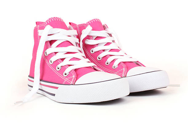 Pair of pink canvas sneakers with white laces /file_thumbview_approve.php?size=1&id=13792859 canvas shoe photos stock pictures, royalty-free photos & images