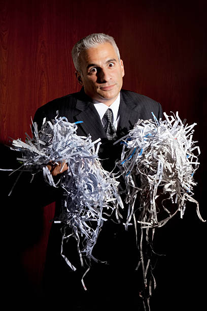 istock Guilty Businessman Holding Shredded Paper 182897438