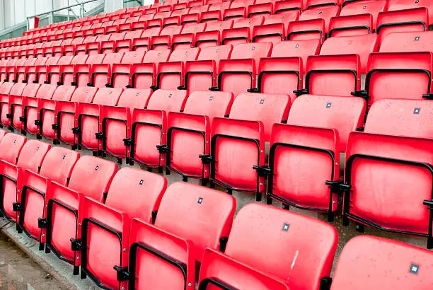Photo of football stadium red seats in norway