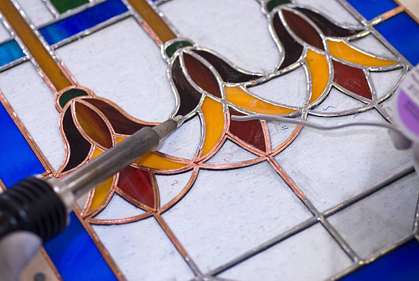 istock Building a Stained Glass Window with Solder 182897583