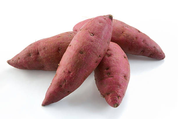 Fresh Red Sweet Potatoes whole red sweet potatoes isolated on white sweet potato stock pictures, royalty-free photos & images