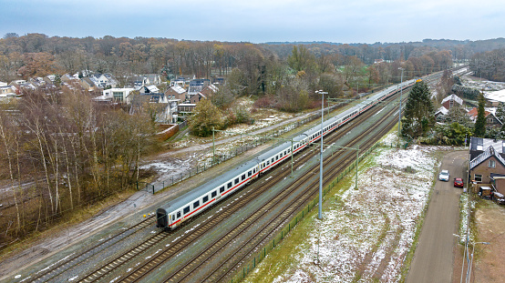 Oldenzaal, Netherlands - December 2, 2023: Aerial view of a Dutch Railways (NS) locomotive in front of some German Railways (DB) passenger wagons.