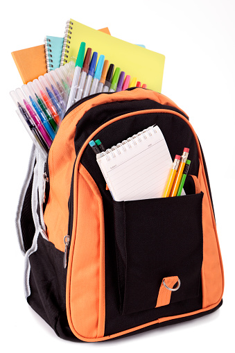 Orange backpack overflowing with various school supplies including notebooks, pens and pencils.  Alternative version of this file shown below: