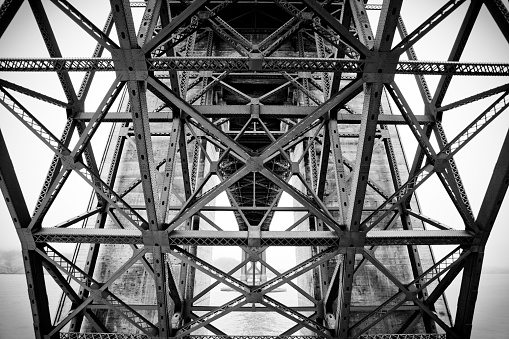 A detail view of the Golden Gate Bridge in black and white.