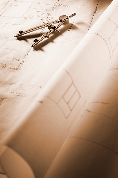 istock Drawing compass lying on blueprints of house 182898666