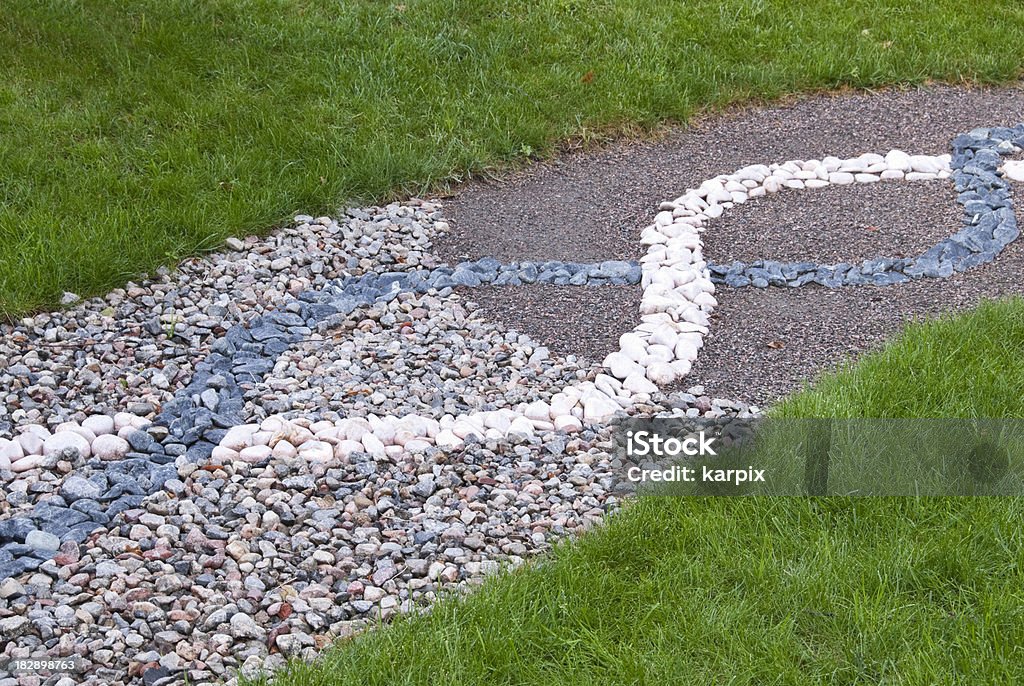 Tricky life way Path in the garden with a wavy stone and gravel ornament symbolizing a tricky life way.From the same series: Ornamental Garden Stock Photo