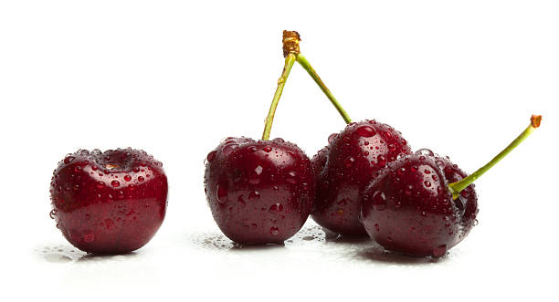 istock Four Fresh Wet Organic Bing Cherries Isolated On White 182898915