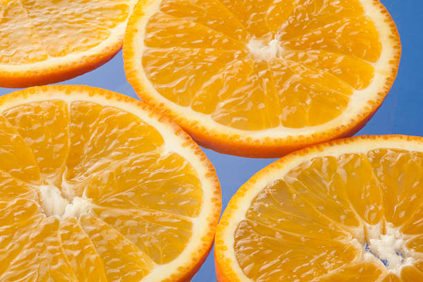istock Delicious Orange Slices on Blue Background 182899119
