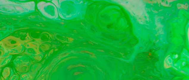 Liquid Green Background. Fluid Art Wallpaper with Colored Spots and Stains on Liquid