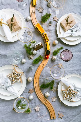 Festive Christmas place setting with small wooden railway