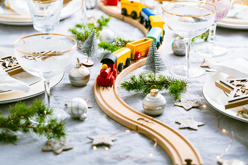 Festive Christmas place setting with small wooden railway