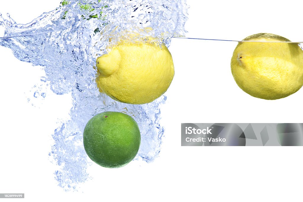 Citrus Splash Picture of lemons and limes splashing into water. Abstract Stock Photo