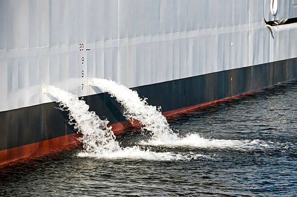 Ballast water pouring from ship Ballast water pouring from ship ballast water stock pictures, royalty-free photos & images