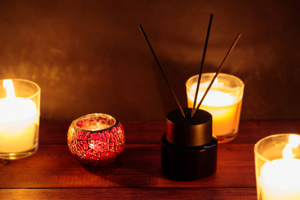 istock Black Reed Diffuser and Burning Candles on Wooden Table, Aromatherapy and Calming Concept 1828997832