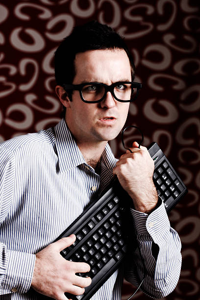 istock Young executive, possibly an IT professional, protects his keyboard frowning 182900025