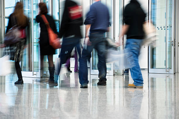 istock Blurred Commuters Walking Through Glass Doors 182900169