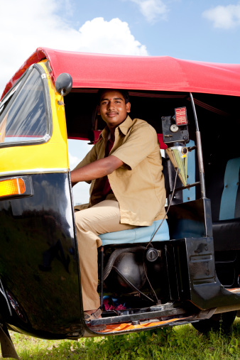 Young Cheerful Indian Auto Rickshaw Driver