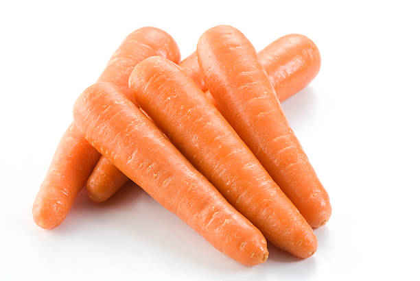 Stack of fresh clean carrots isolated on white background Isolated carrots with vibrant colour ready for your design & print. pile of carrots stock pictures, royalty-free photos & images