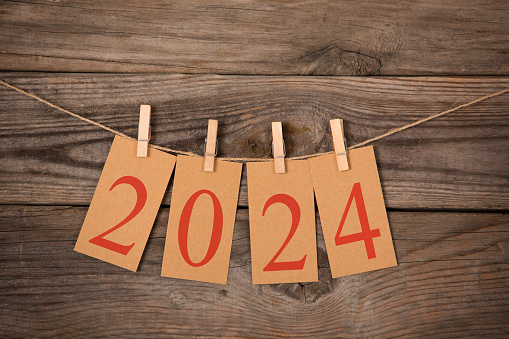 New Year 2024 Concepts Clipped Cards on Wood Background