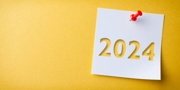 istock White Sticky Note With Happy New Year 2024 And Red Push Pin On Yellow Cardboard Background 1829005239