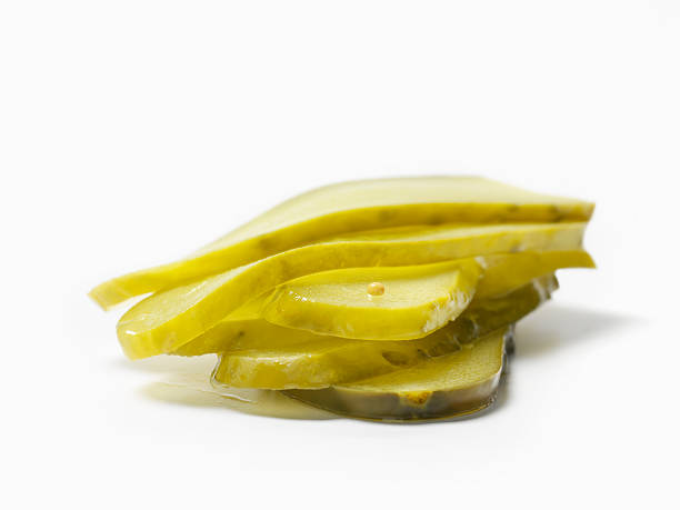 Dill Pickle slices Dill Pickle slices -Photographed on Hasselblad H3D2-39mb Camera dill pickle stock pictures, royalty-free photos & images