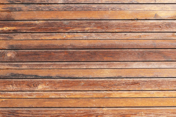 istock Natural wooden texture. Wood background. Plank with knot. Board structure. Brown color impregnated outdoor wood pattern. Bright backdrop. 1829007936