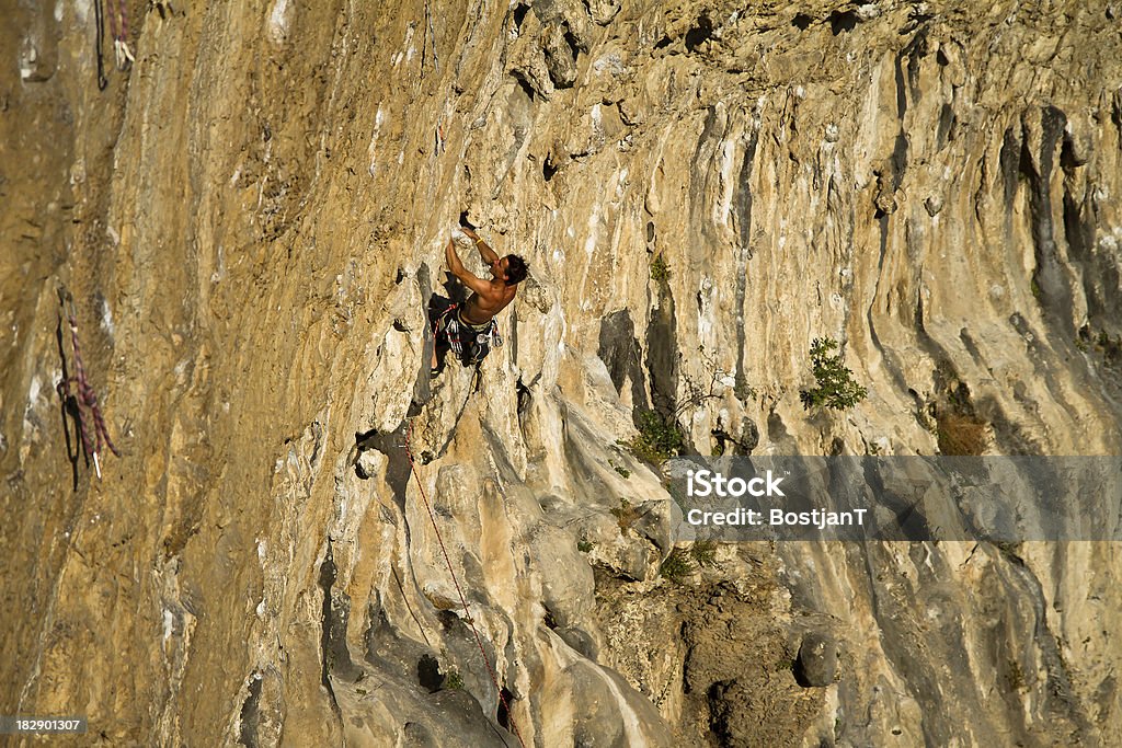 Rock climbing Young athlete is climbing up to the top. Activity Stock Photo