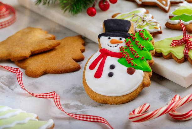 istock Homemade Christmas cookies decorated with icing on white background. 1829016933