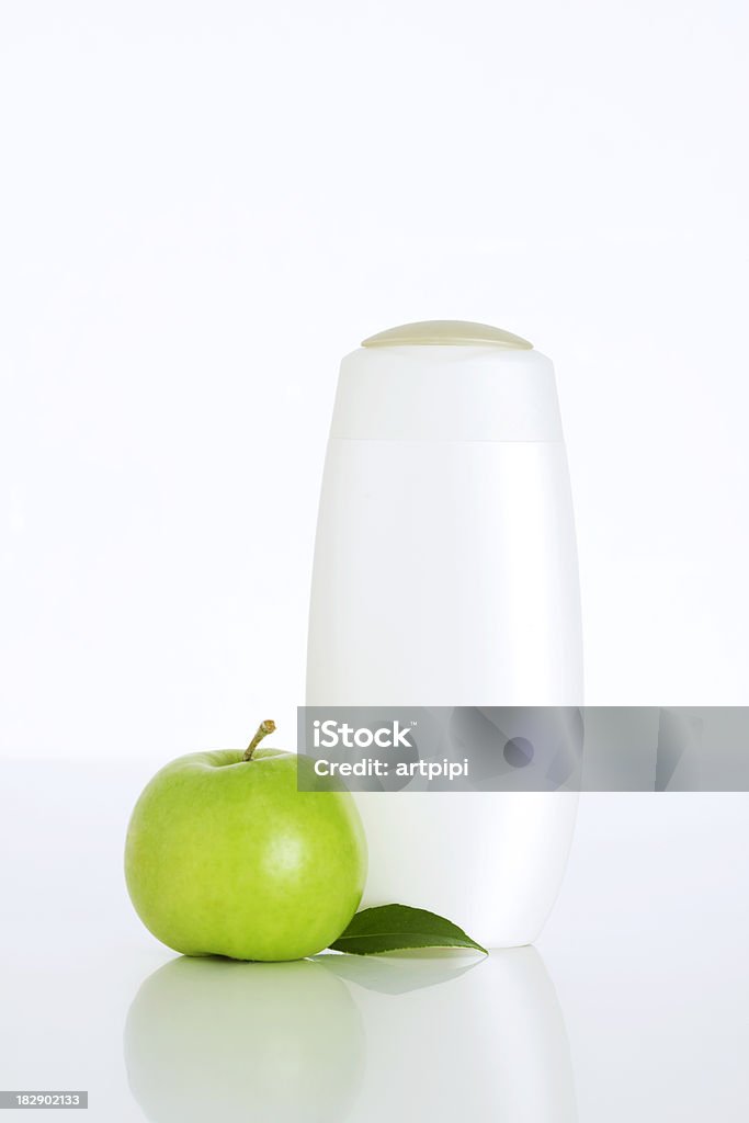 Plastic bottle and green apple Plastic bottle for lotion, soap, shampoo and green apple. isolated on white background Apple - Fruit Stock Photo