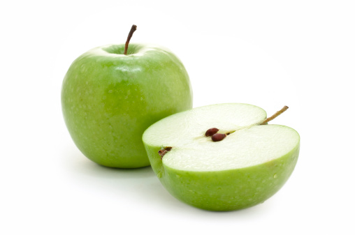 Whole and cut open green apple on white background.More food images: