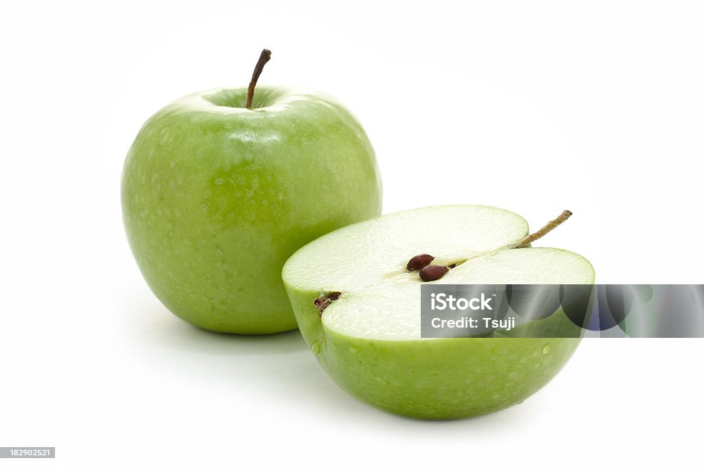 Green apple Whole and cut open green apple on white background.More food images: Apple - Fruit Stock Photo