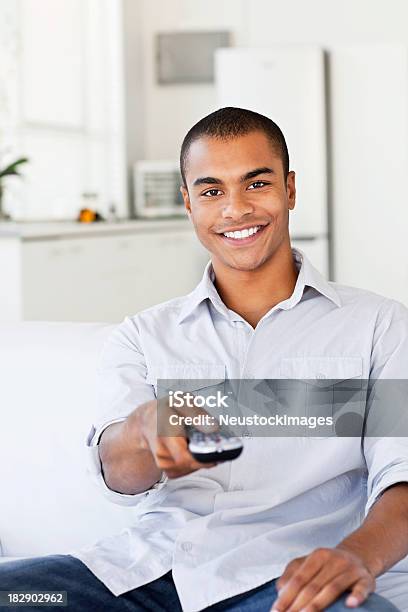 Young Man Watching Television Stock Photo - Download Image Now - 20-29 Years, Adult, Adults Only