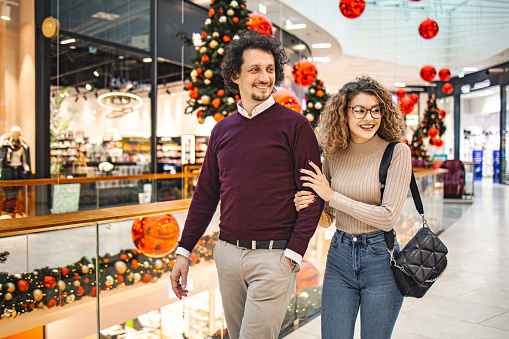 Young couple in the shopping mall buying Christmas presents