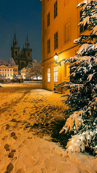 Snowy square with Christmas market in Prague, evening