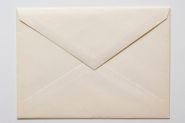 Isolated shot of closed an old envelope on white background Close-up shot of closed an old envelope isolated on white background. correspondence stock pictures, royalty-free photos & images