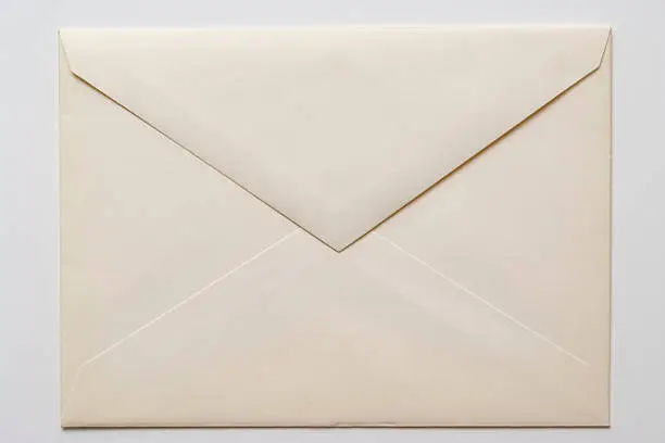 Photo of Isolated shot of closed an old envelope on white background
