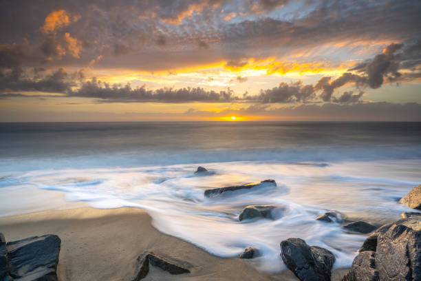 istock Beautiful east coast sunrise on a rocky beach 1829034934