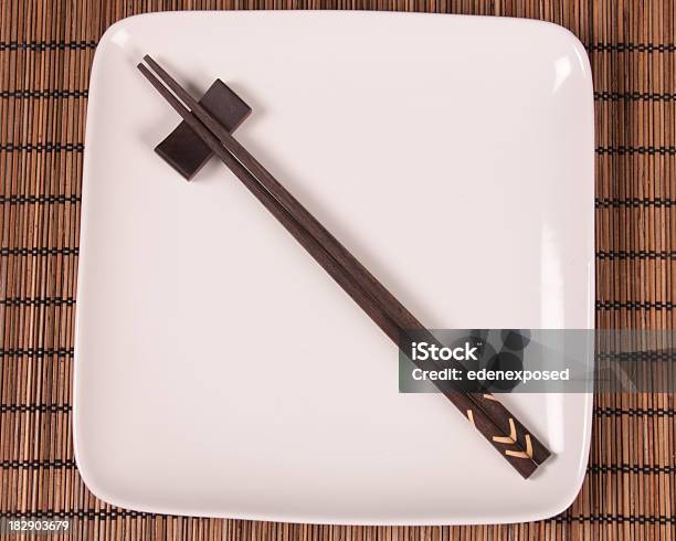 Chopsticks On White Plate Stock Photo - Download Image Now - Chopsticks, Chopsticks Rest, Bamboo - Material