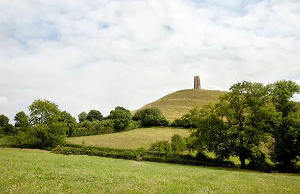 "Glastonbury Tor, Somerset, England viewed from a meadow on a summer day."