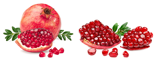 pomegranate fruit with green leaves and seeds isolated on a white background. clipping path