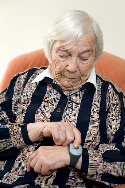 Elderly lady using emergency call system stock photo