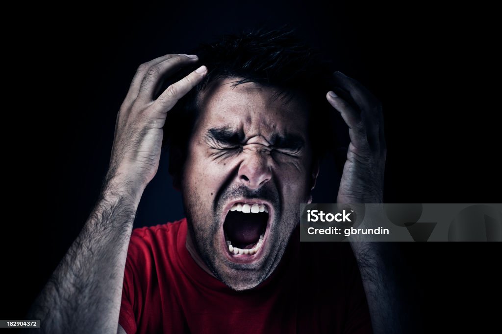 Dark man screaming "Dark man screaming, dark/black background." Shouting Stock Photo