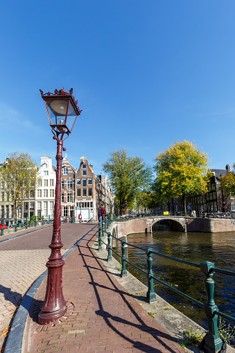 Canal and bridges traditional Dutch houses at Keizersgracht portrait format traveling in Amsterdam, Netherlands